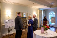 Jeremy-Stubbs-Dallas-Housing-Program-Manager-explaining-the-key-display-to-sponsors-Cindi-and-Jay-Anthony